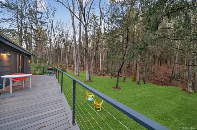 a view of a wooden deck and a backyard