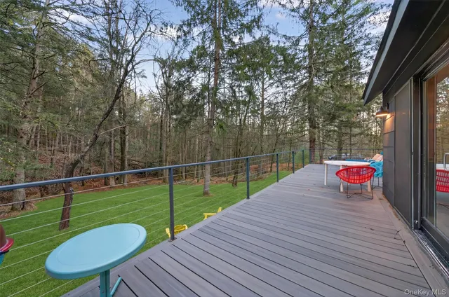 a backyard of a house with table and chairs