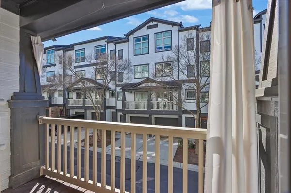 a view of a brick house with many windows