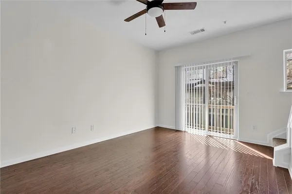 wooden floor in an empty room with a window