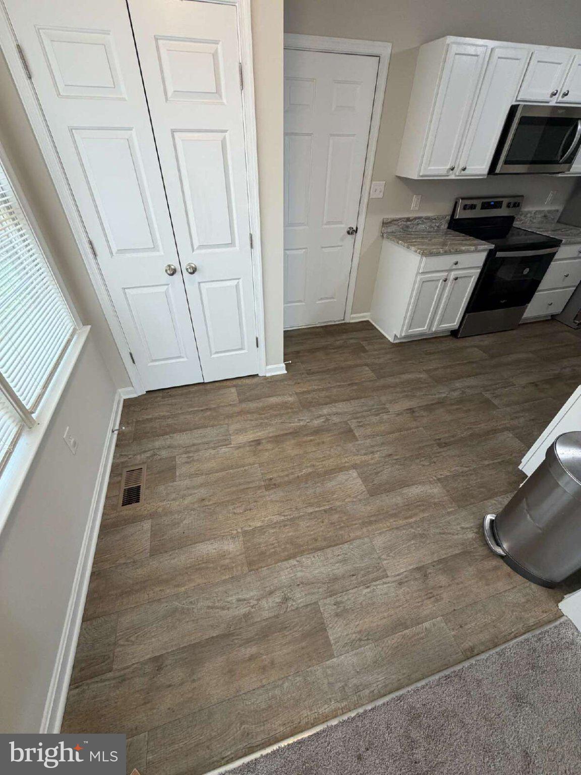 313 3rd Street Colonial Beach, VA 22443 - Photo 6 of 36 Modern kitchen with stylish flooring.