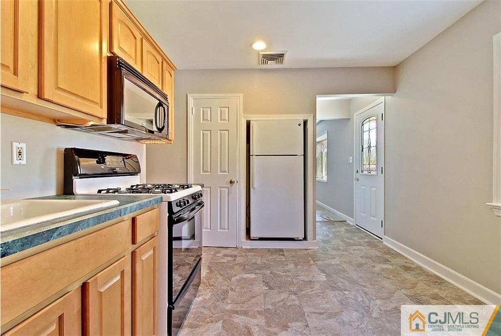 32 Ramsey Road Middlesex, NJ 08846 - Photo 11 of 25 a kitchen with stainless steel appliances granite countertop a refrigerator a stove and a sink