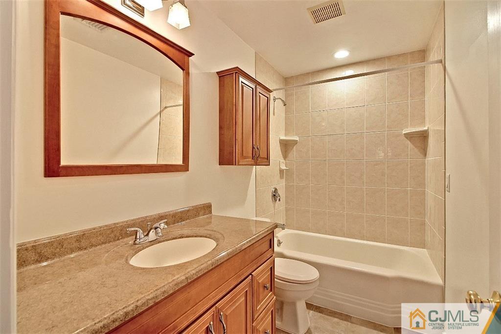 32 Ramsey Road Middlesex, NJ 08846 - Photo 14 of 25 a bathroom with a sink a toilet and shower