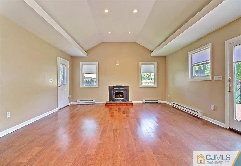 32 Ramsey Road Middlesex, NJ 08846 - Photo 8 of 25 an empty room with wooden floor and windows