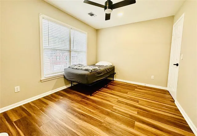 a view of a backyard with potted plants and trees