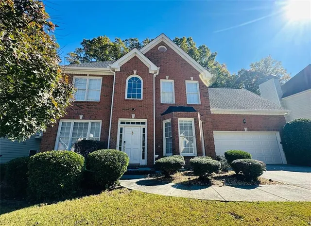 a view of a workspace with furniture and wooden floor