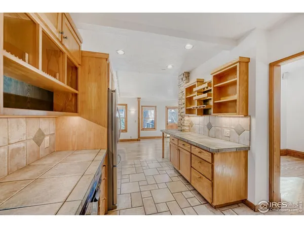 a kitchen with stainless steel appliances granite countertop a sink and cabinets