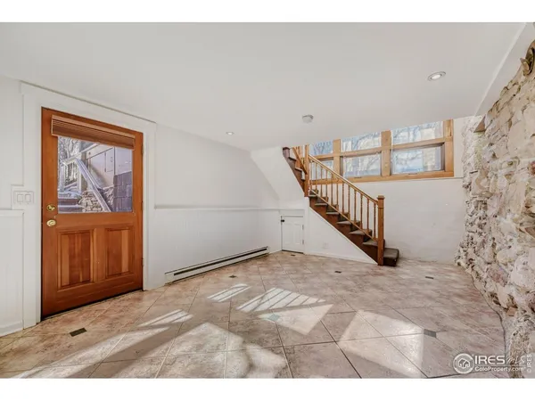 a view of an entryway with wooden floor