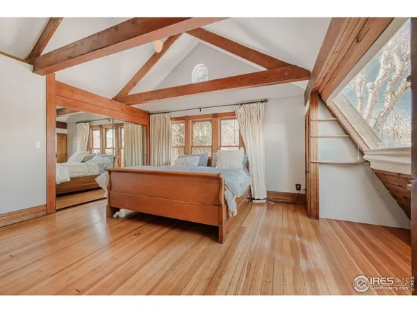 a spacious bedroom with a bed and a large window