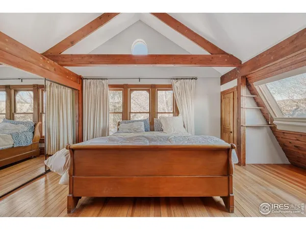 a view of bedroom with a bed and wooden floor