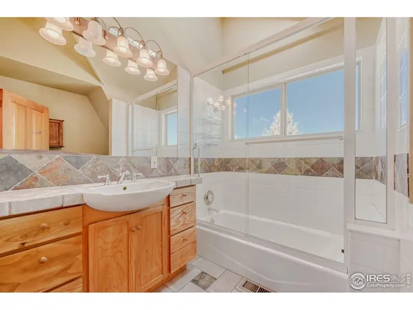 a bathroom with a sink a mirror and a bathtub