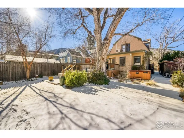 a view of a house with a yard covered in snow