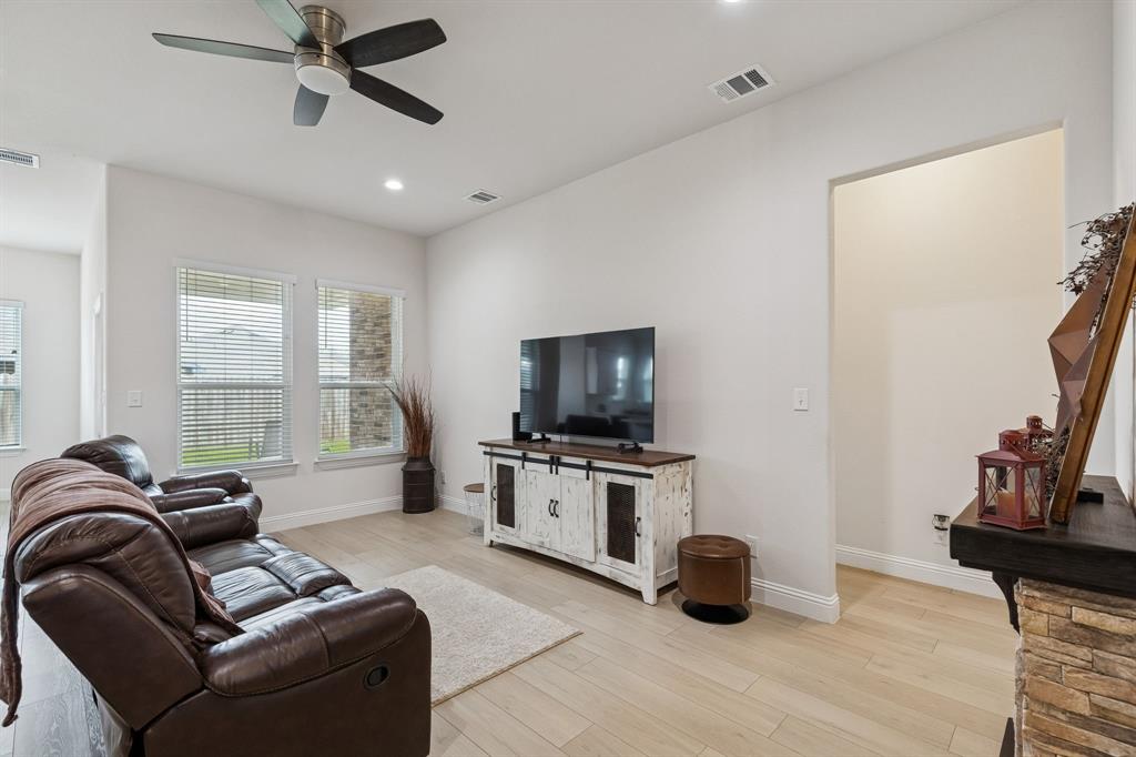 388 Montague Street Pilot Point, TX 76258 - Photo 10 of 28 a living room with furniture and a flat screen tv