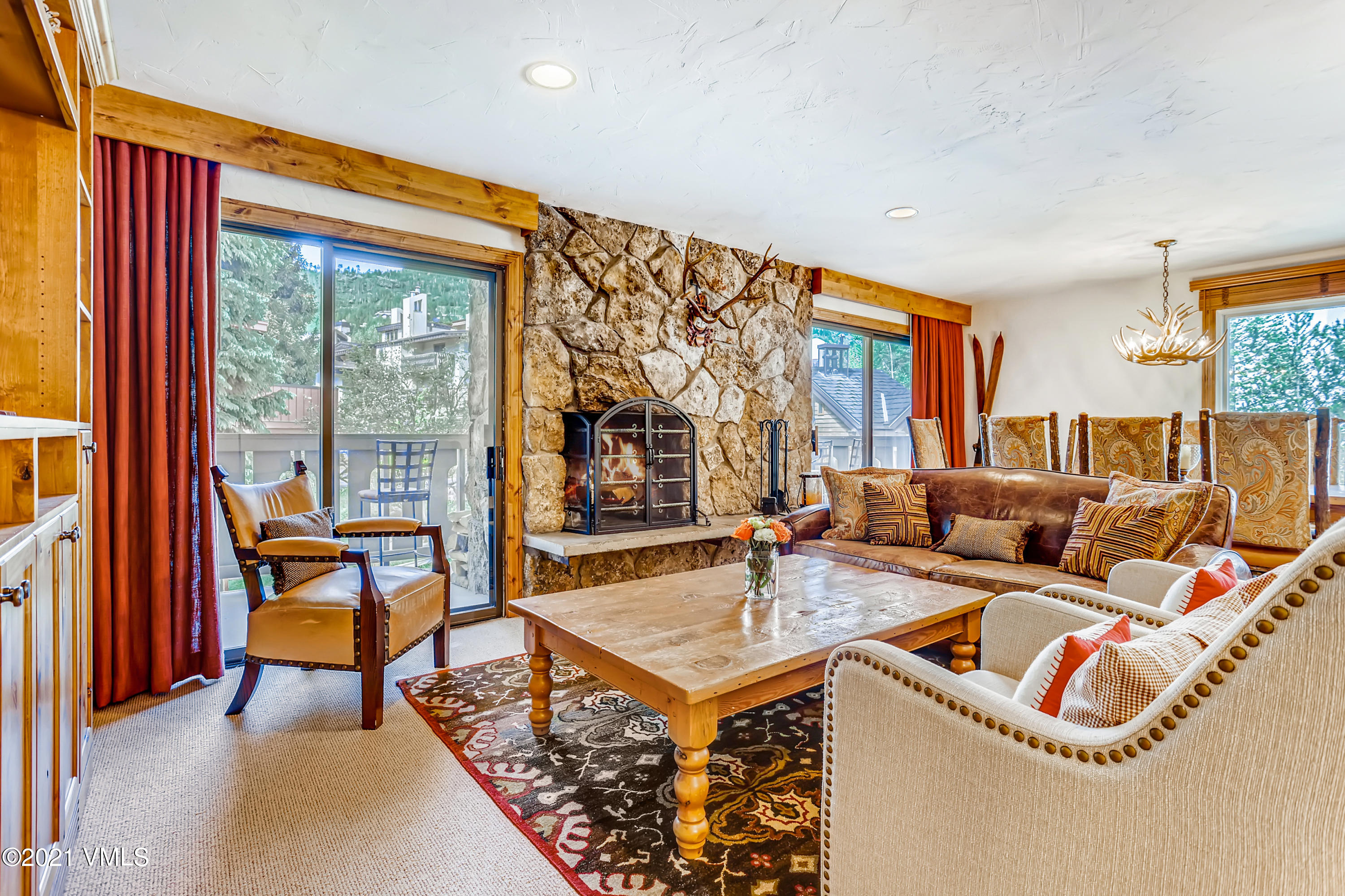 a living room with furniture a table and a large window