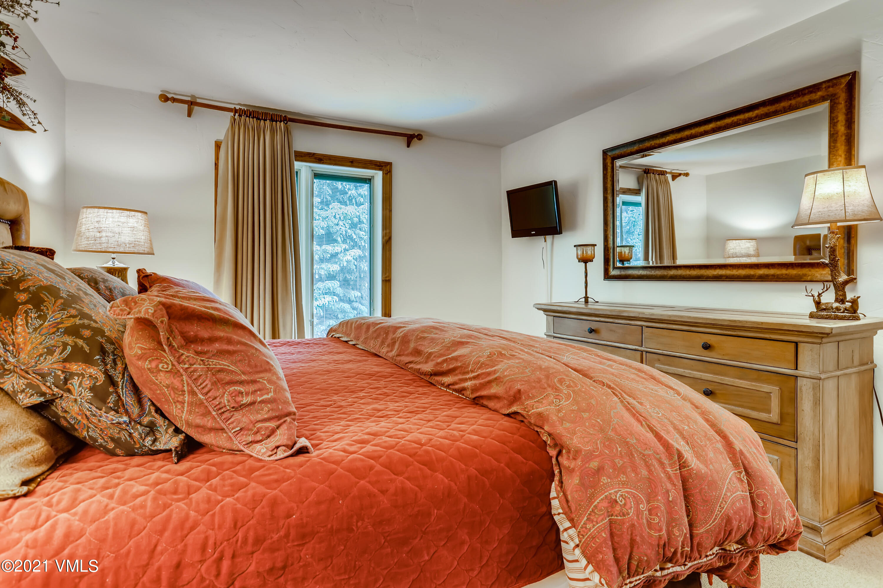 133 Willow Bridge Road, Unit 625 Vail, CO 81657 - Photo 13 of 26 a bedroom with a bed and flat screen tv