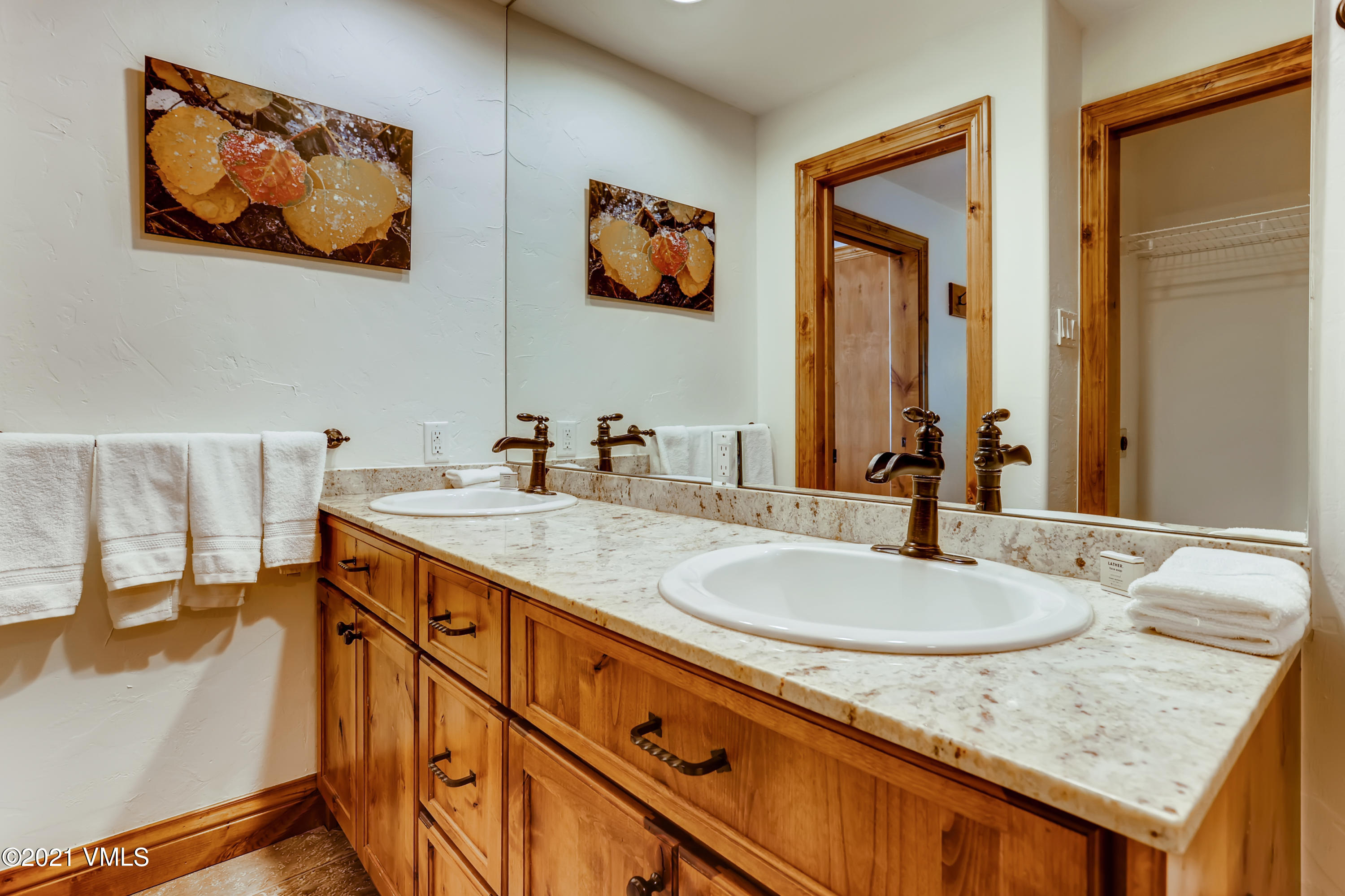 133 Willow Bridge Road, Unit 625 Vail, CO 81657 - Photo 15 of 26 a bathroom with a granite countertop sink and a mirror
