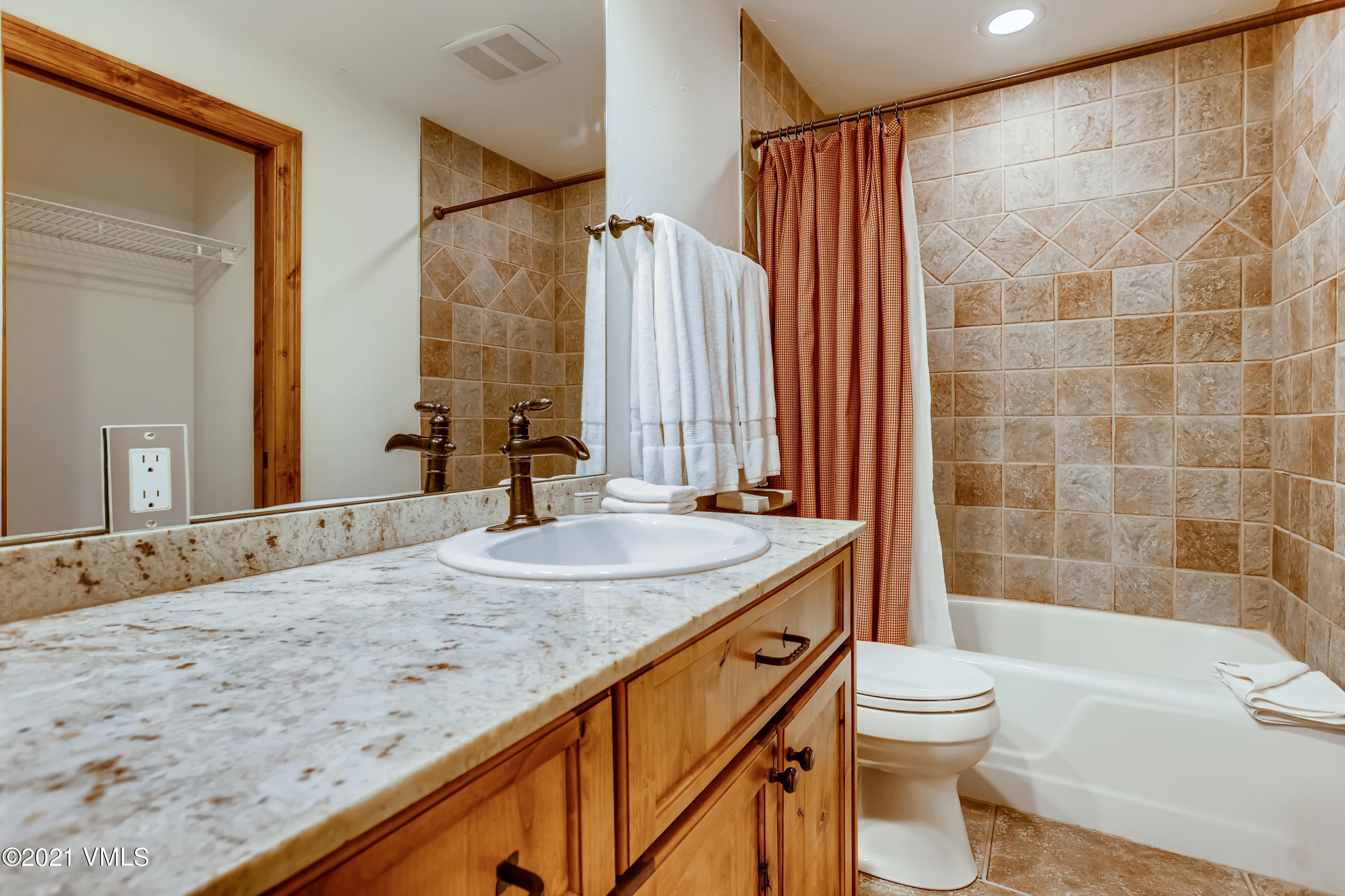 133 Willow Bridge Road, Unit 625 Vail, CO 81657 - Photo 16 of 26 a bathroom with a granite countertop sink toilet and shower