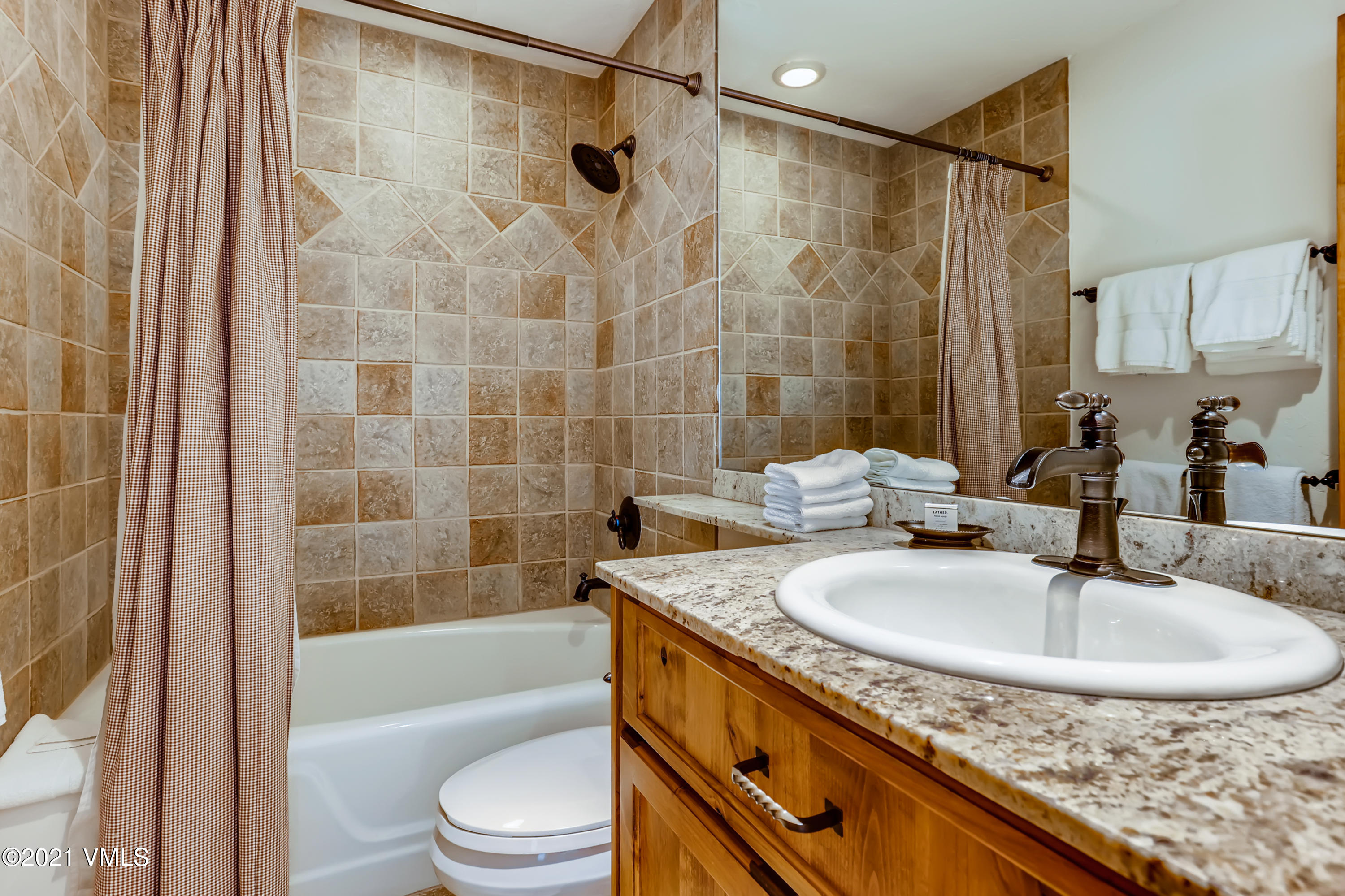 133 Willow Bridge Road, Unit 625 Vail, CO 81657 - Photo 19 of 26 a bathroom with a granite countertop sink a toilet and shower