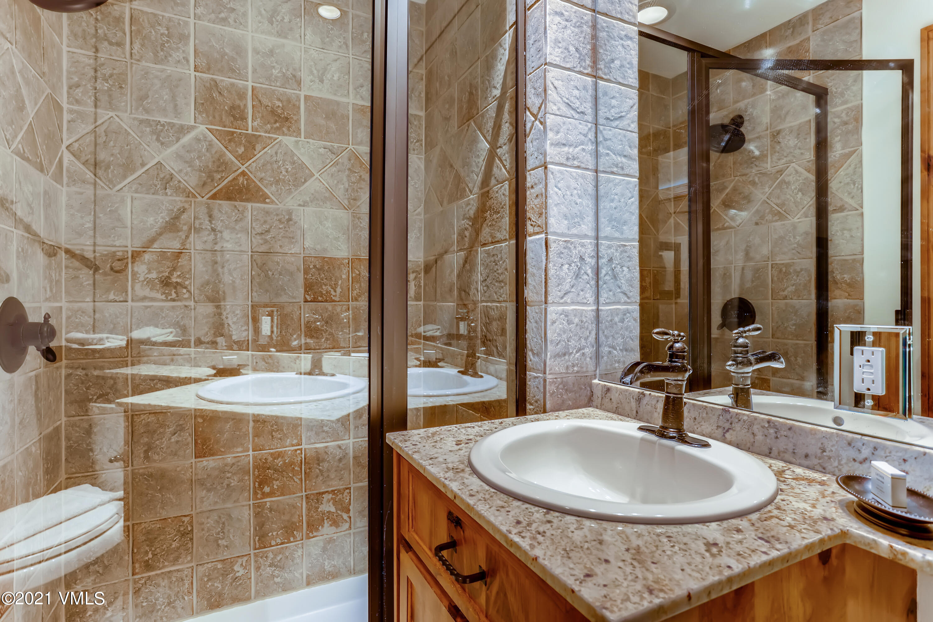 133 Willow Bridge Road, Unit 625 Vail, CO 81657 - Photo 23 of 26 a bathroom with a granite countertop sink and a mirror