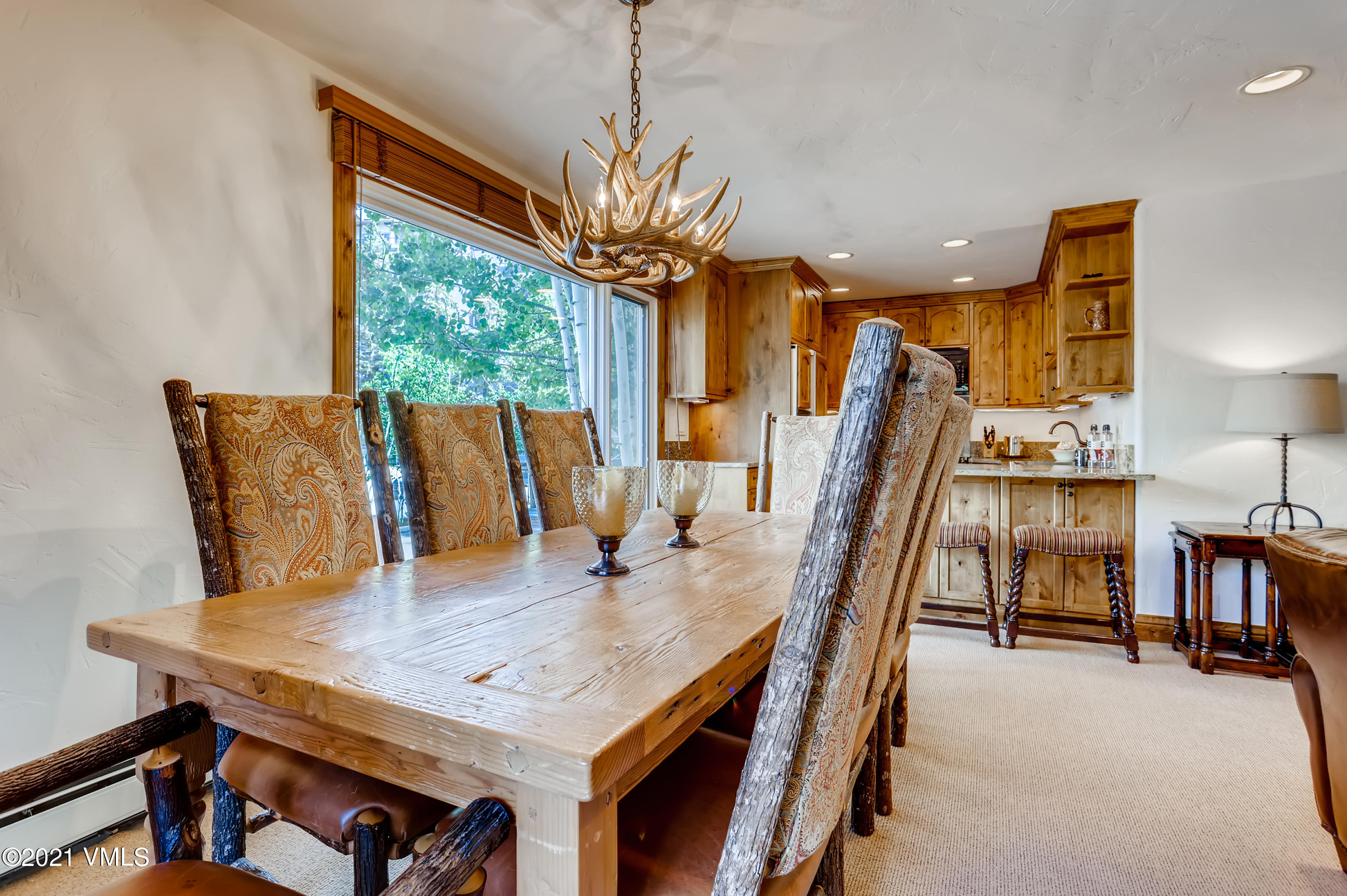 133 Willow Bridge Road, Unit 625 Vail, CO 81657 - Photo 7 of 26 a view of a dining room with furniture window and wooden floor