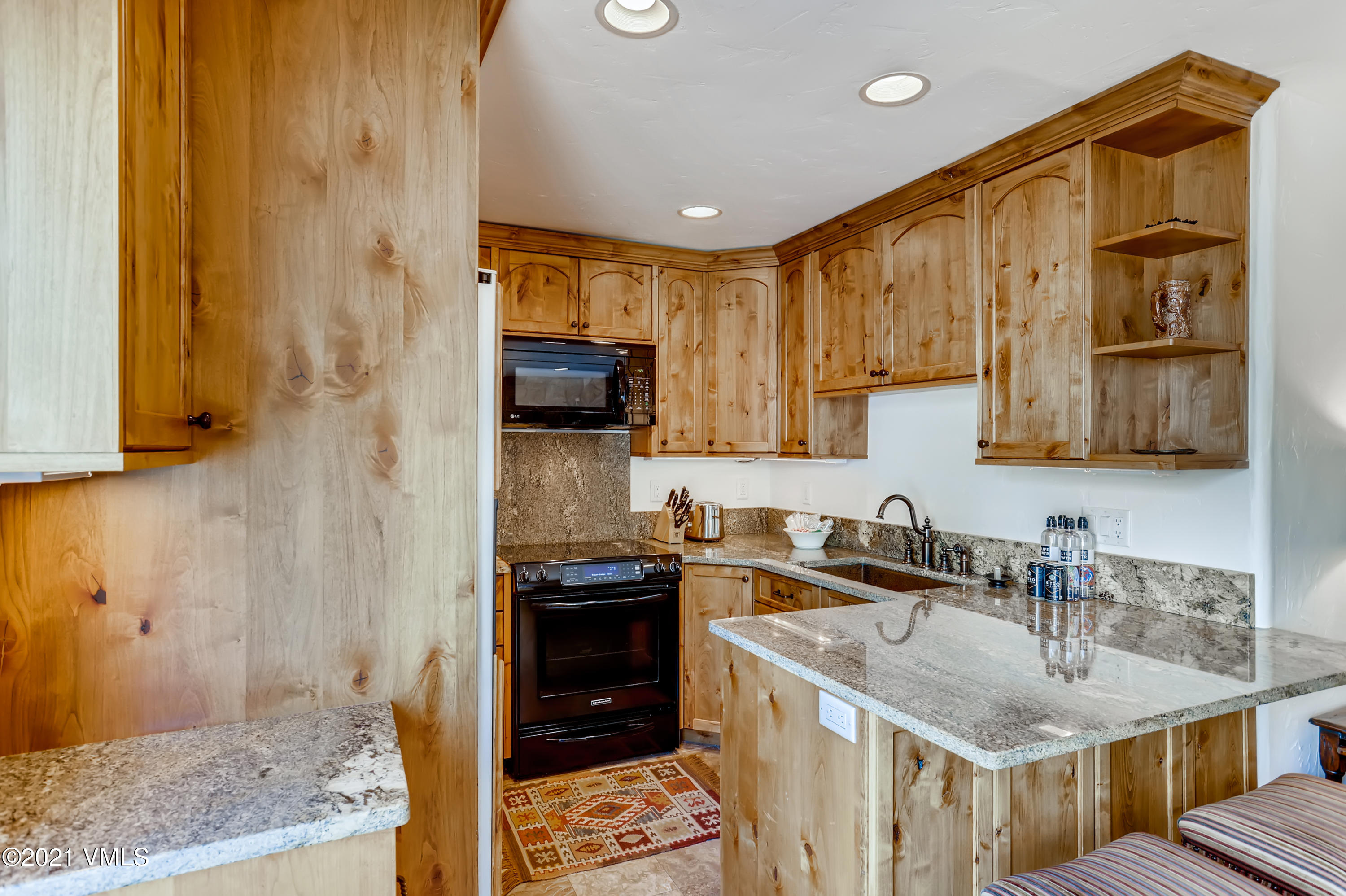 133 Willow Bridge Road, Unit 625 Vail, CO 81657 - Photo 9 of 26 a kitchen with stainless steel appliances granite countertop a sink stove and refrigerator