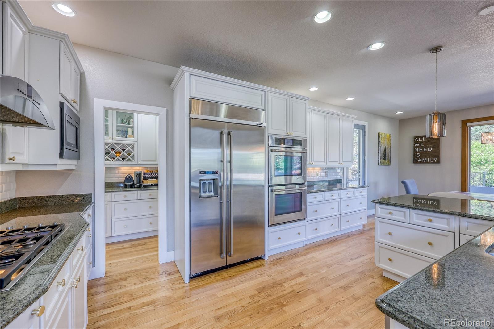 7963 Glen Ridge Drive Castle Pines, CO 80108 - Photo 13 of 48 a kitchen with stainless steel appliances granite countertop a refrigerator a stove and a sink