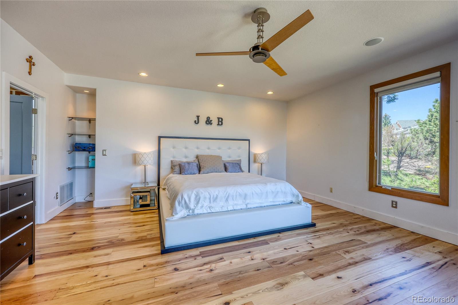 7963 Glen Ridge Drive Castle Pines, CO 80108 - Photo 16 of 48 a bedroom with a bed and wooden floor