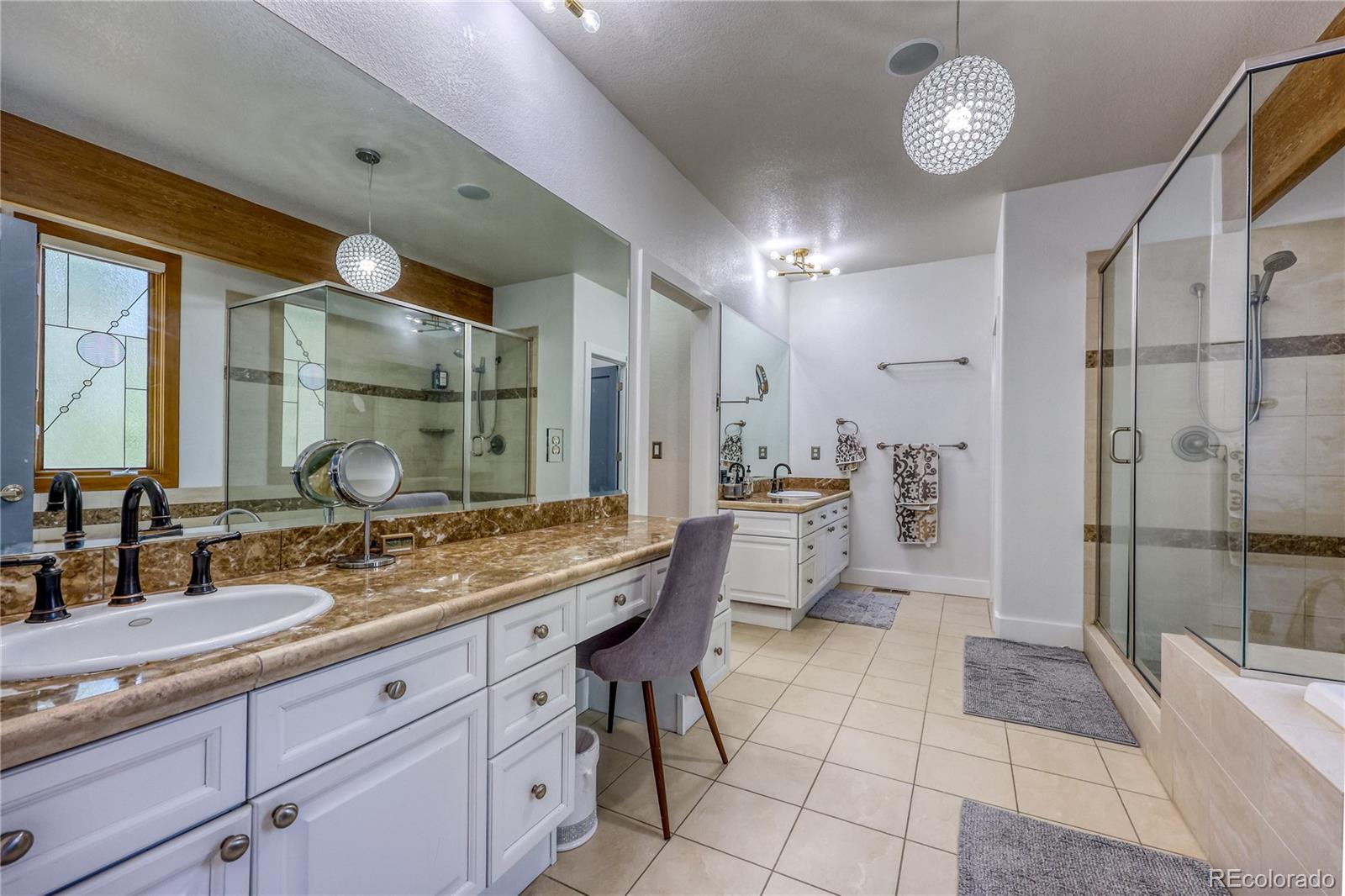 7963 Glen Ridge Drive Castle Pines, CO 80108 - Photo 18 of 48 a bathroom with a granite countertop sink mirror and shower