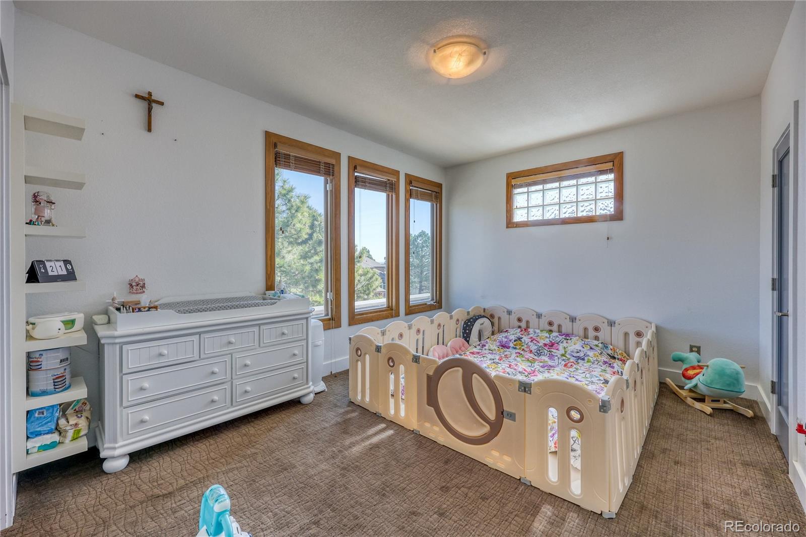 7963 Glen Ridge Drive Castle Pines, CO 80108 - Photo 24 of 48 a bedroom with a bed and a window