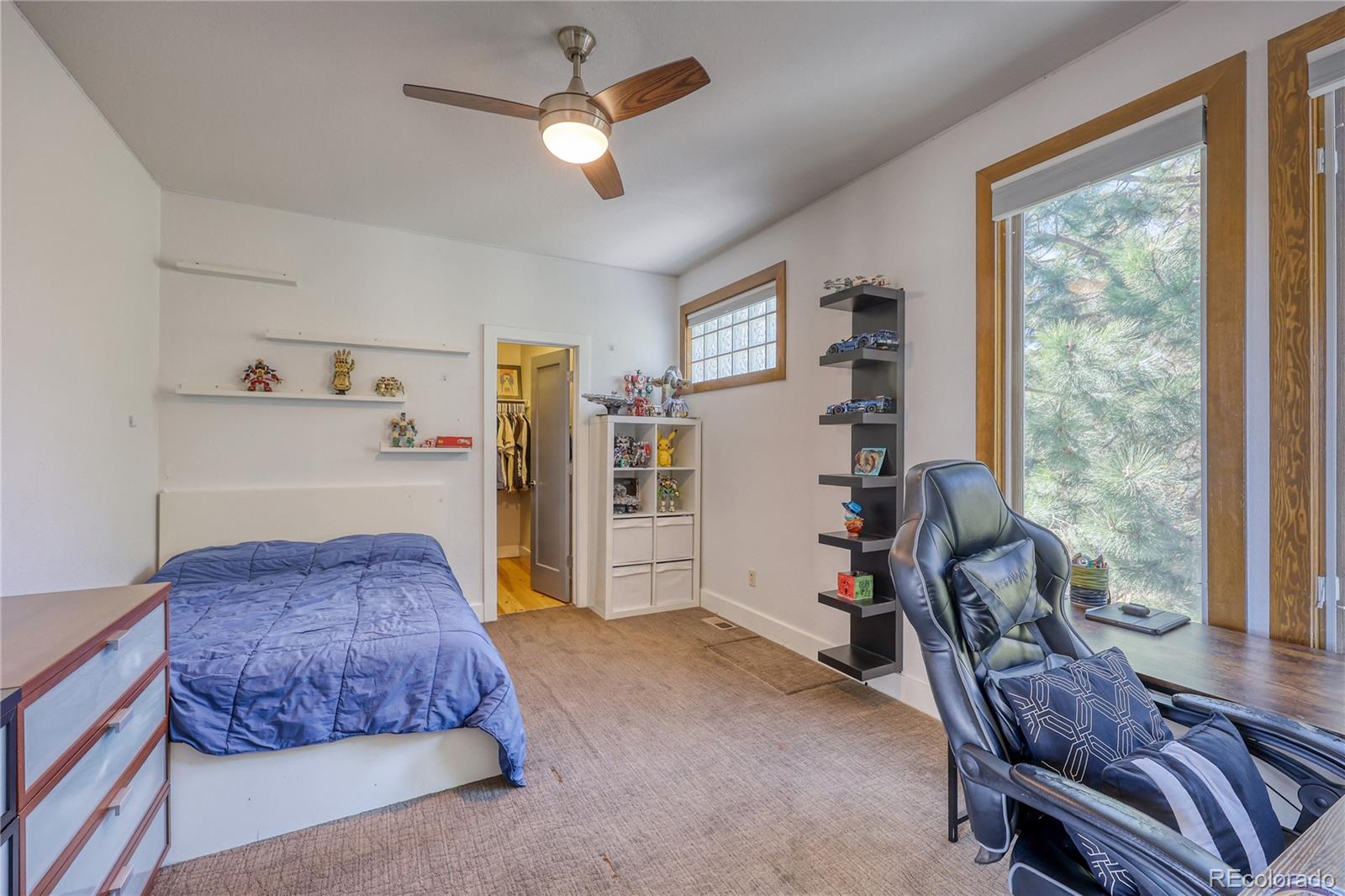 7963 Glen Ridge Drive Castle Pines, CO 80108 - Photo 26 of 48 a bedroom with a bed and a chandelier