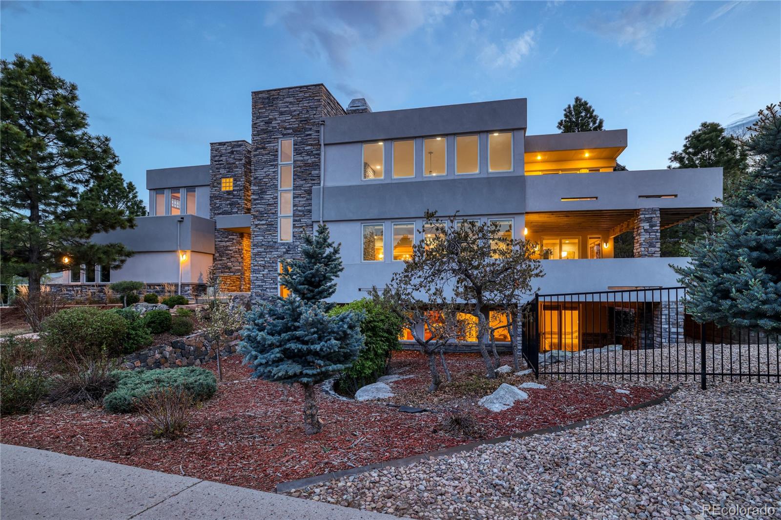 7963 Glen Ridge Drive Castle Pines, CO 80108 - Photo 3 of 48 a front view of a house with a yard