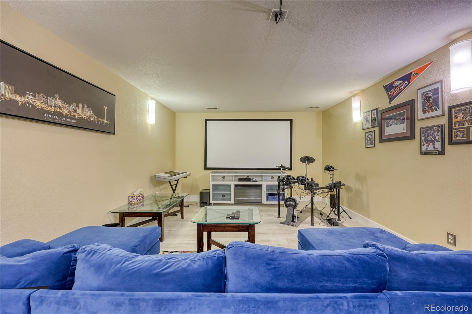 7963 Glen Ridge Drive Castle Pines, CO 80108 - Photo 32 of 48 a living room with furniture and a flat screen tv