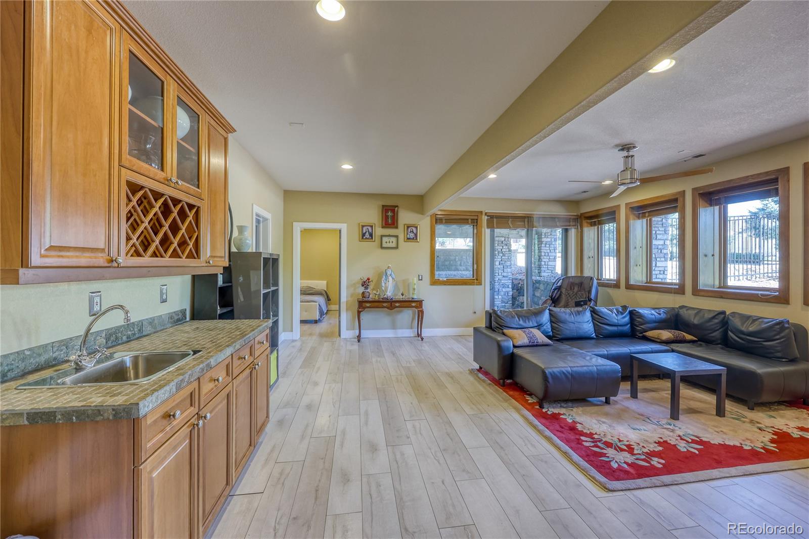 7963 Glen Ridge Drive Castle Pines, CO 80108 - Photo 33 of 48 a living room with furniture and a wooden floor