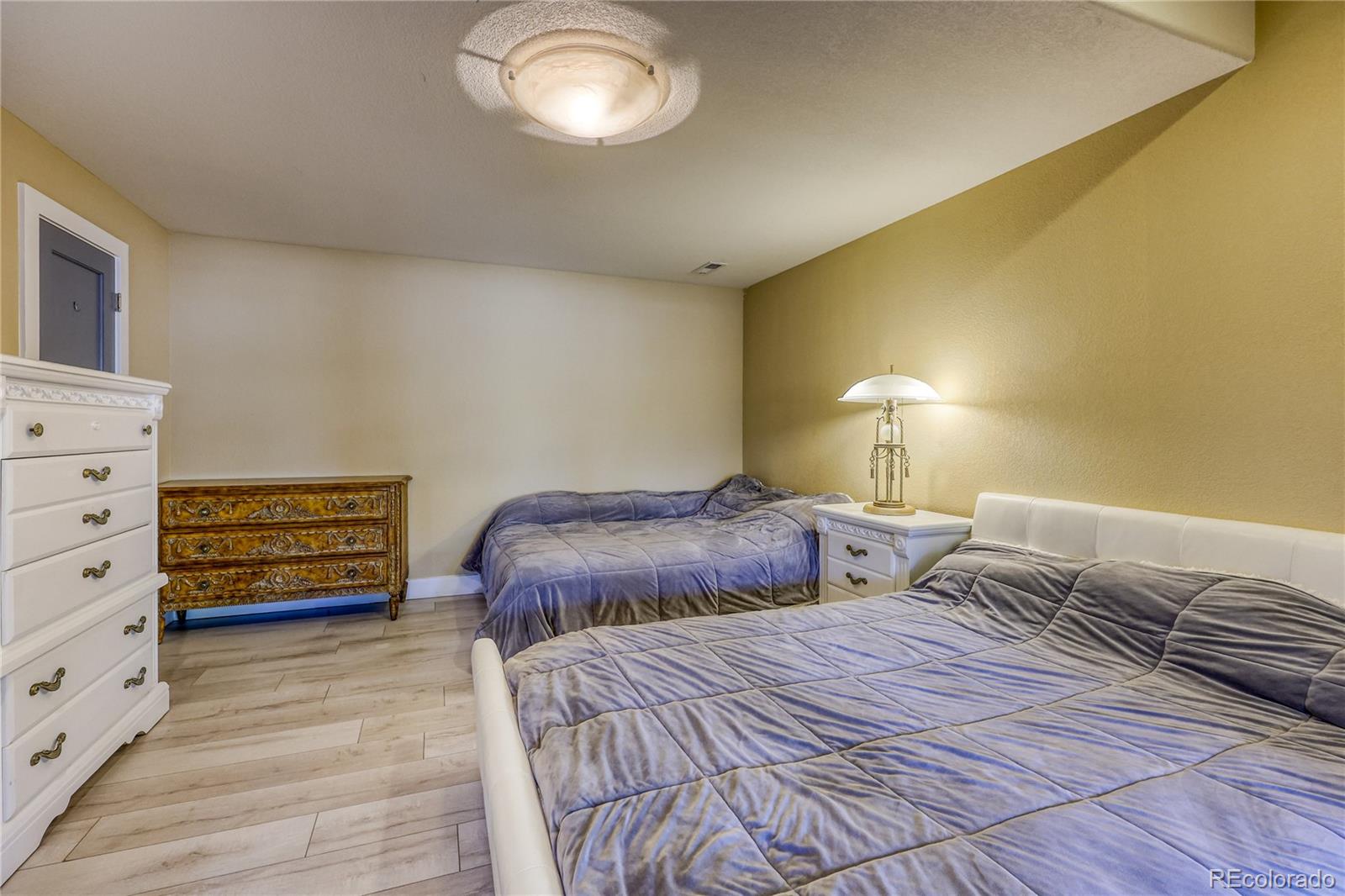 7963 Glen Ridge Drive Castle Pines, CO 80108 - Photo 35 of 48 a bedroom with a bed and a dresser