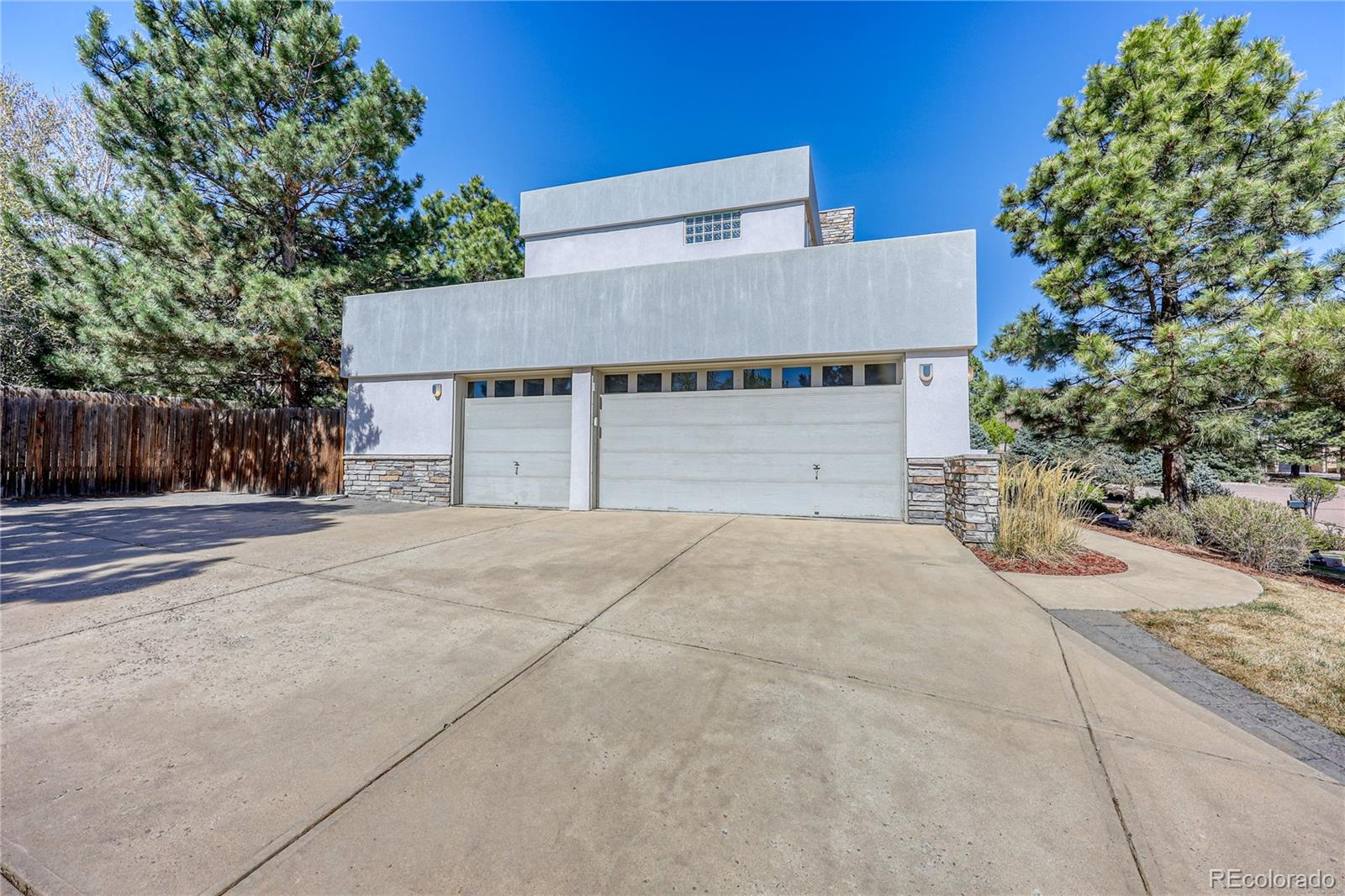 7963 Glen Ridge Drive Castle Pines, CO 80108 - Photo 37 of 48 a front view of a house with a yard and garage