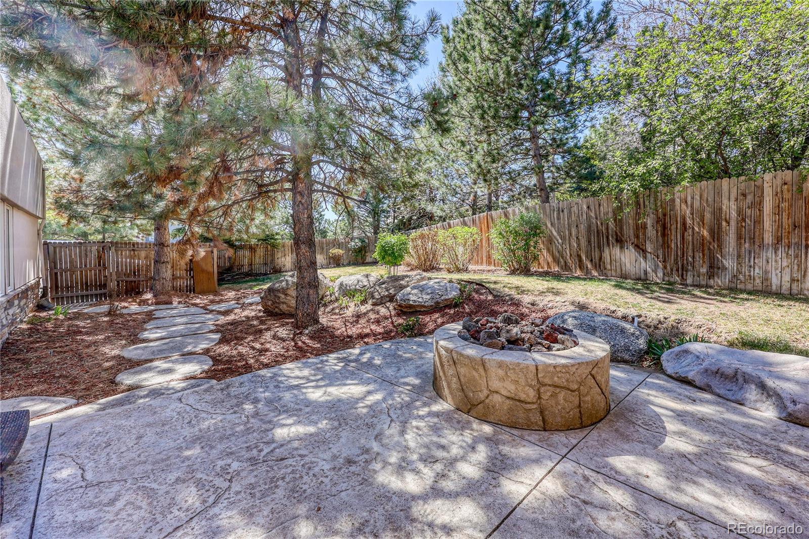 7963 Glen Ridge Drive Castle Pines, CO 80108 - Photo 40 of 48 a view of a backyard with plants and tree