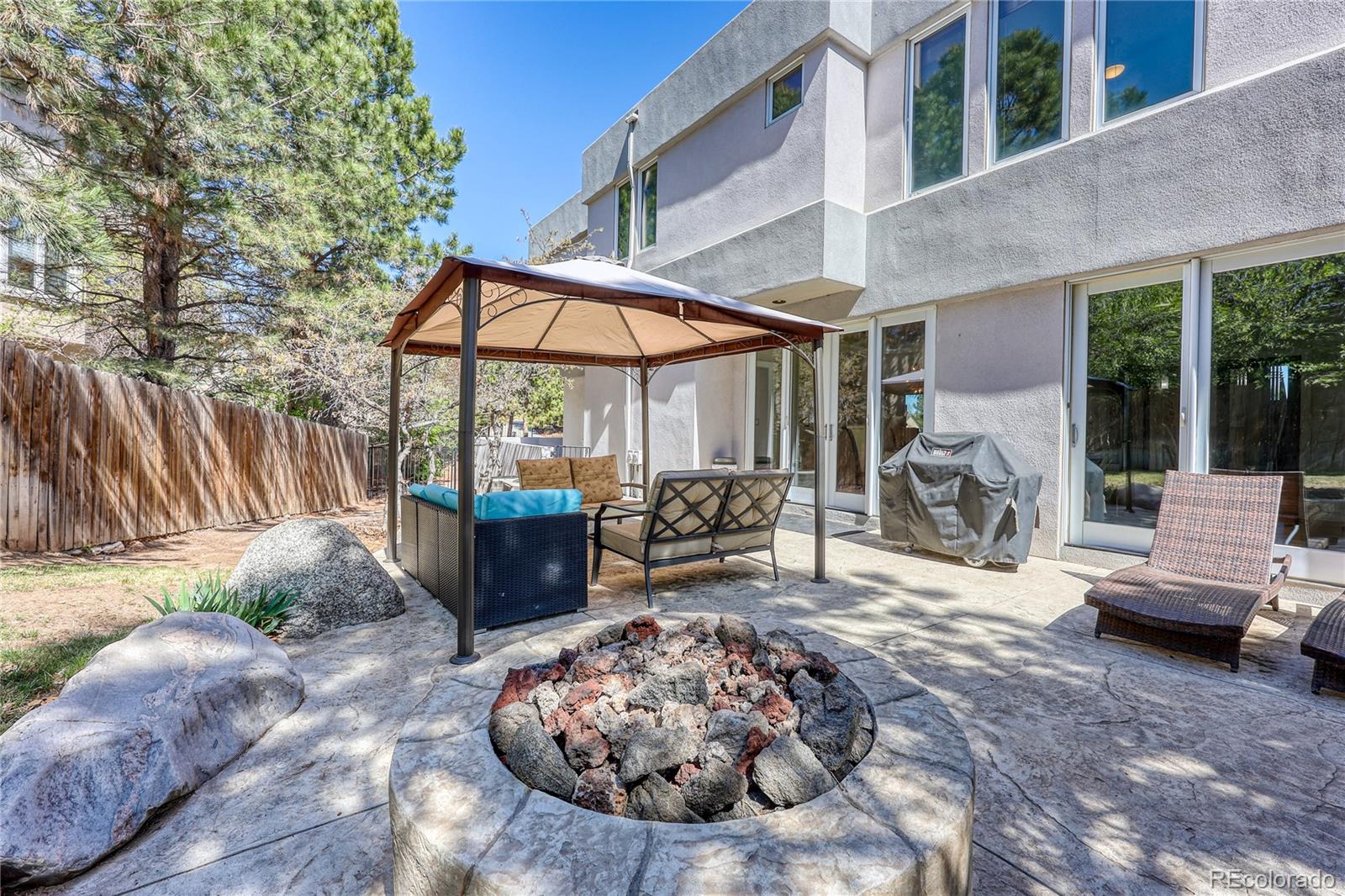 7963 Glen Ridge Drive Castle Pines, CO 80108 - Photo 41 of 48 a view of a patio with a table and chairs