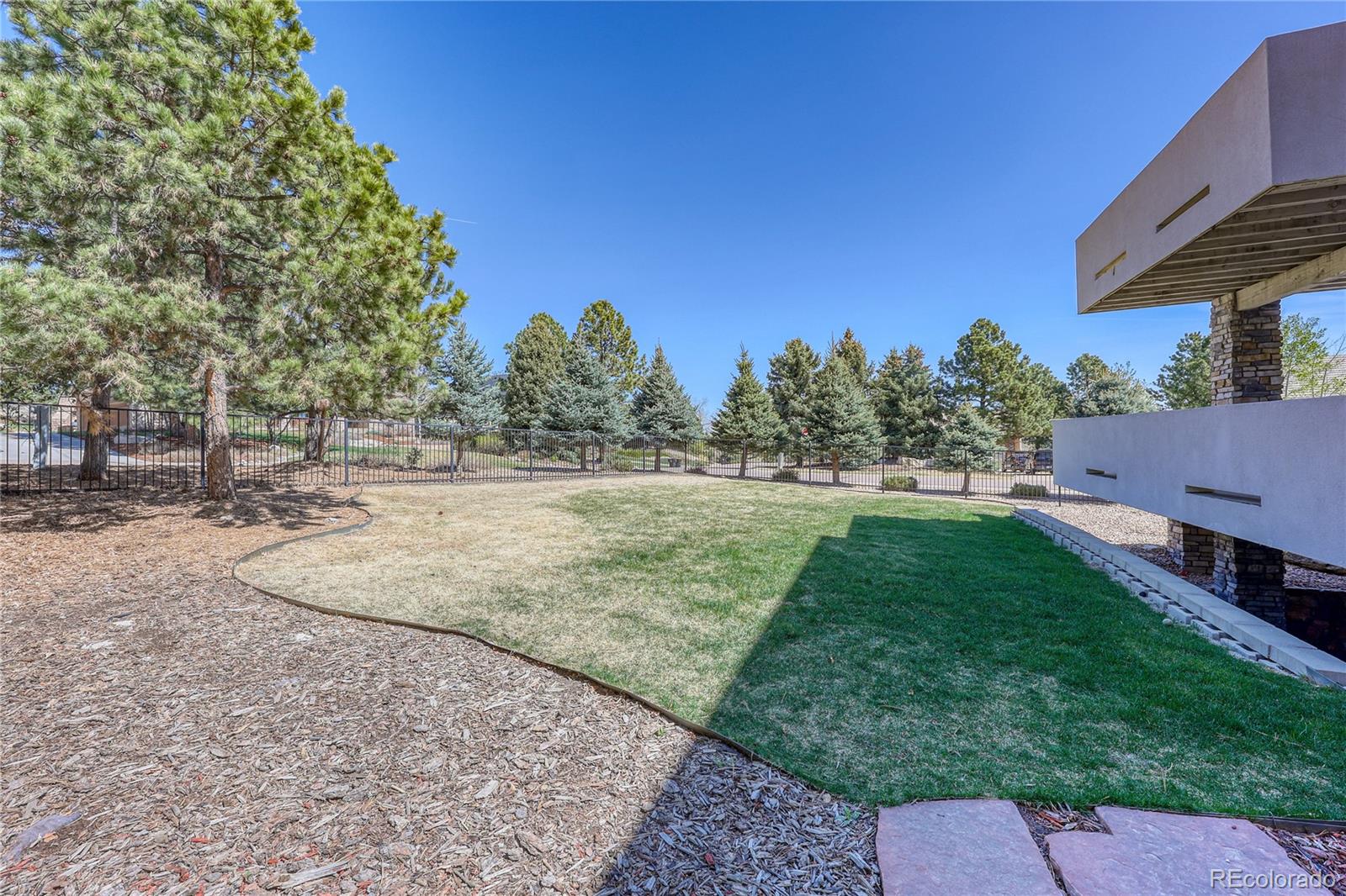 7963 Glen Ridge Drive Castle Pines, CO 80108 - Photo 42 of 48 a view of a backyard