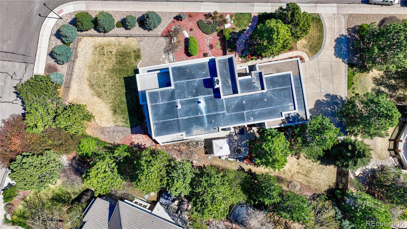 7963 Glen Ridge Drive Castle Pines, CO 80108 - Photo 48 of 48 an aerial view of a house with a garden