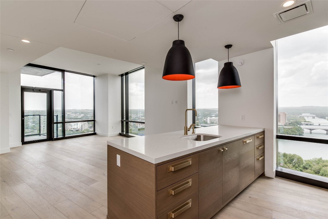 a kitchen with a sink and a large window