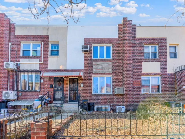 a front view of a building with balcony and patio