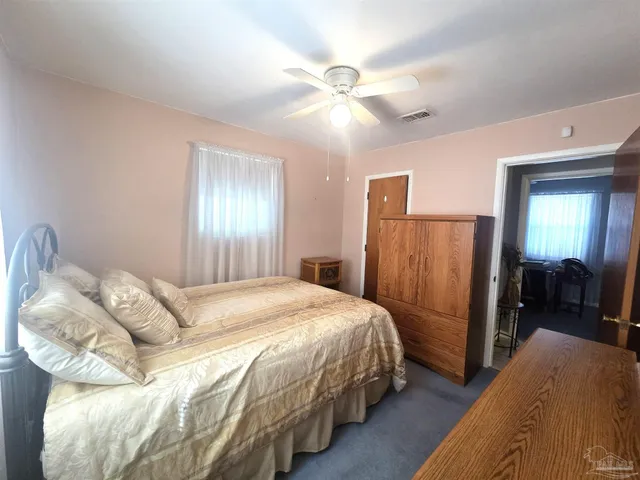a bedroom with bed and a chandelier