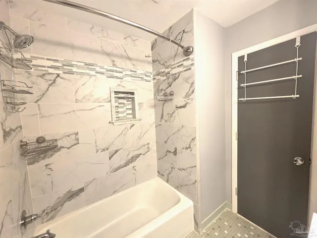 a bathroom with a bathtub and shower