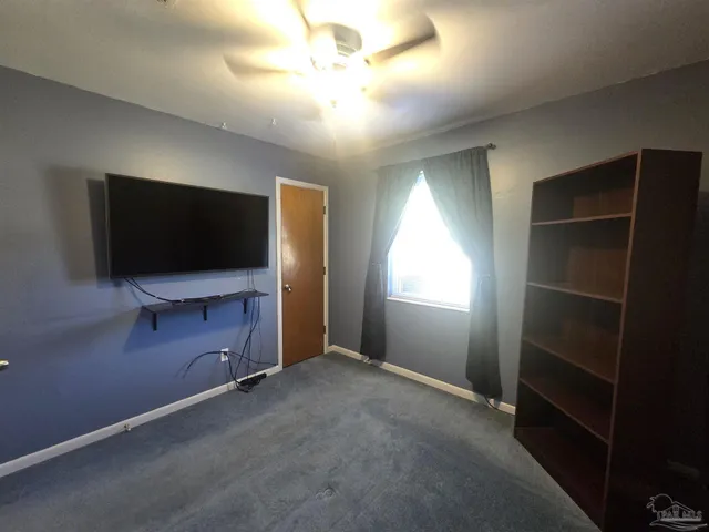 a view of room with flat screen tv and window
