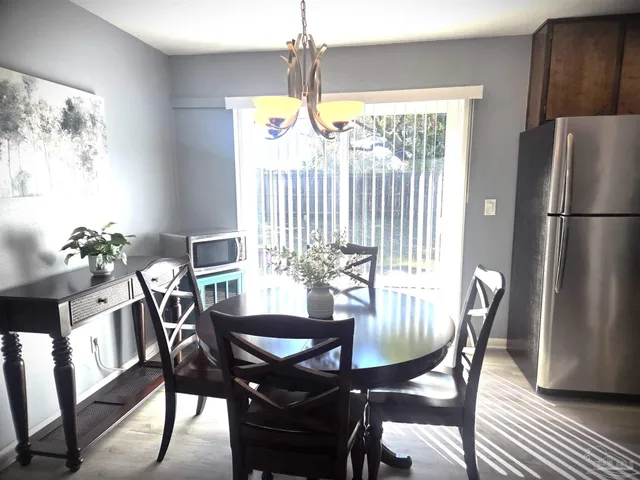 a view of a dining room with furniture window and outside view