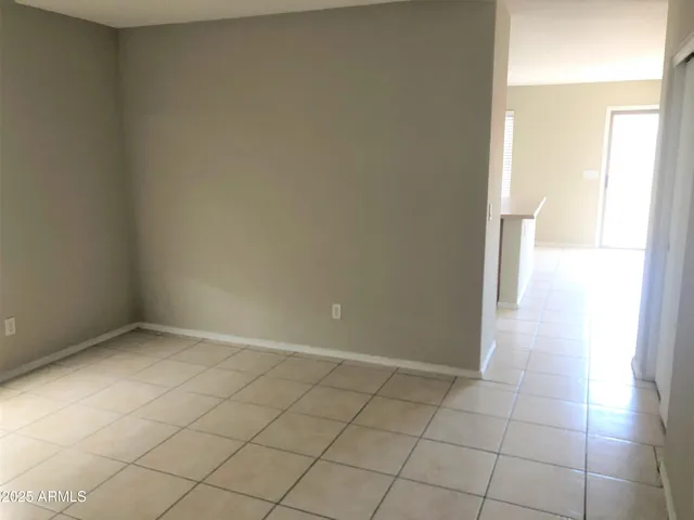 an empty room and a bathroom