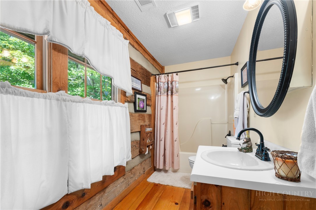 2177 Homestead Road Todd, NC 28684 - Photo 19 of 49 a bathroom with a sink a mirror and a shower