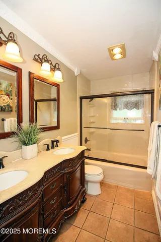 a bathroom with a sink a toilet and mirror