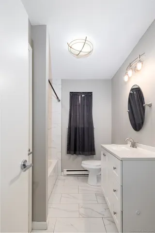 a bathroom with a sink a toilet and a mirror