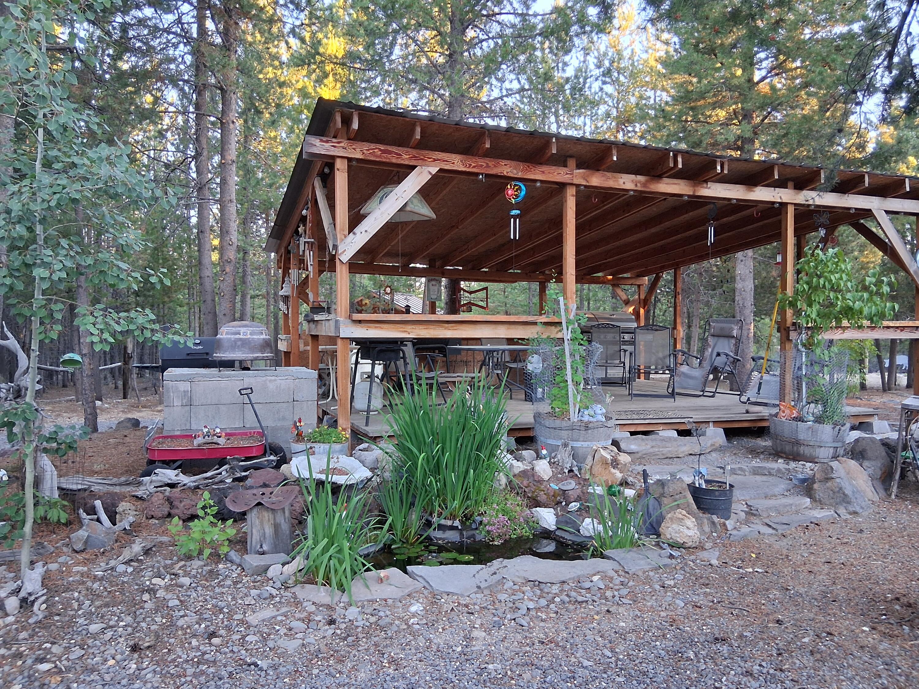 123977 Surveyor Road Crescent Lake, OR 97733 - Photo 6 of 41 a view of patio with table and chairs under an umbrella